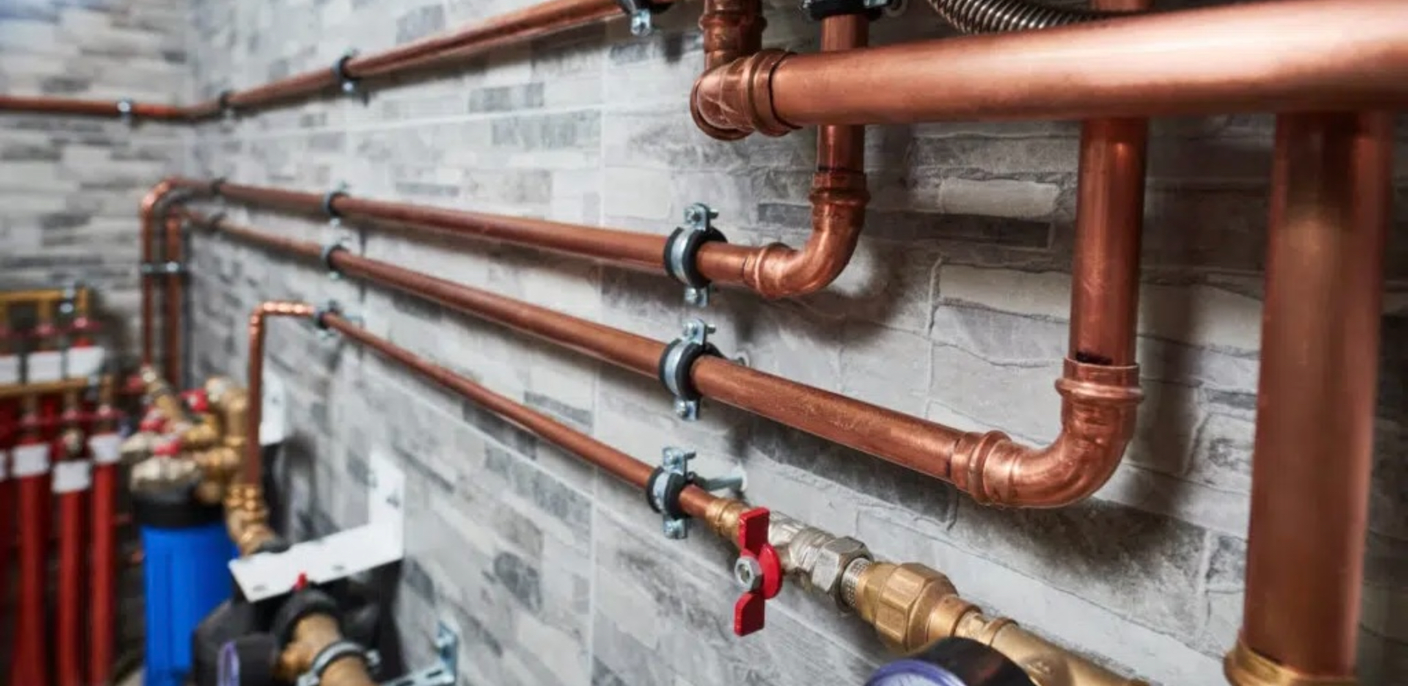 Image of a Commercial building with copper piping attached to a wall 